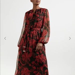 Ted Baker Rococo button down dress in black w/
blouson sleeves.
Midi length